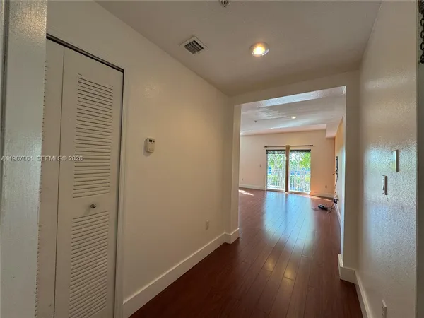 a view of a living room with kitchen countertops and wooden floor