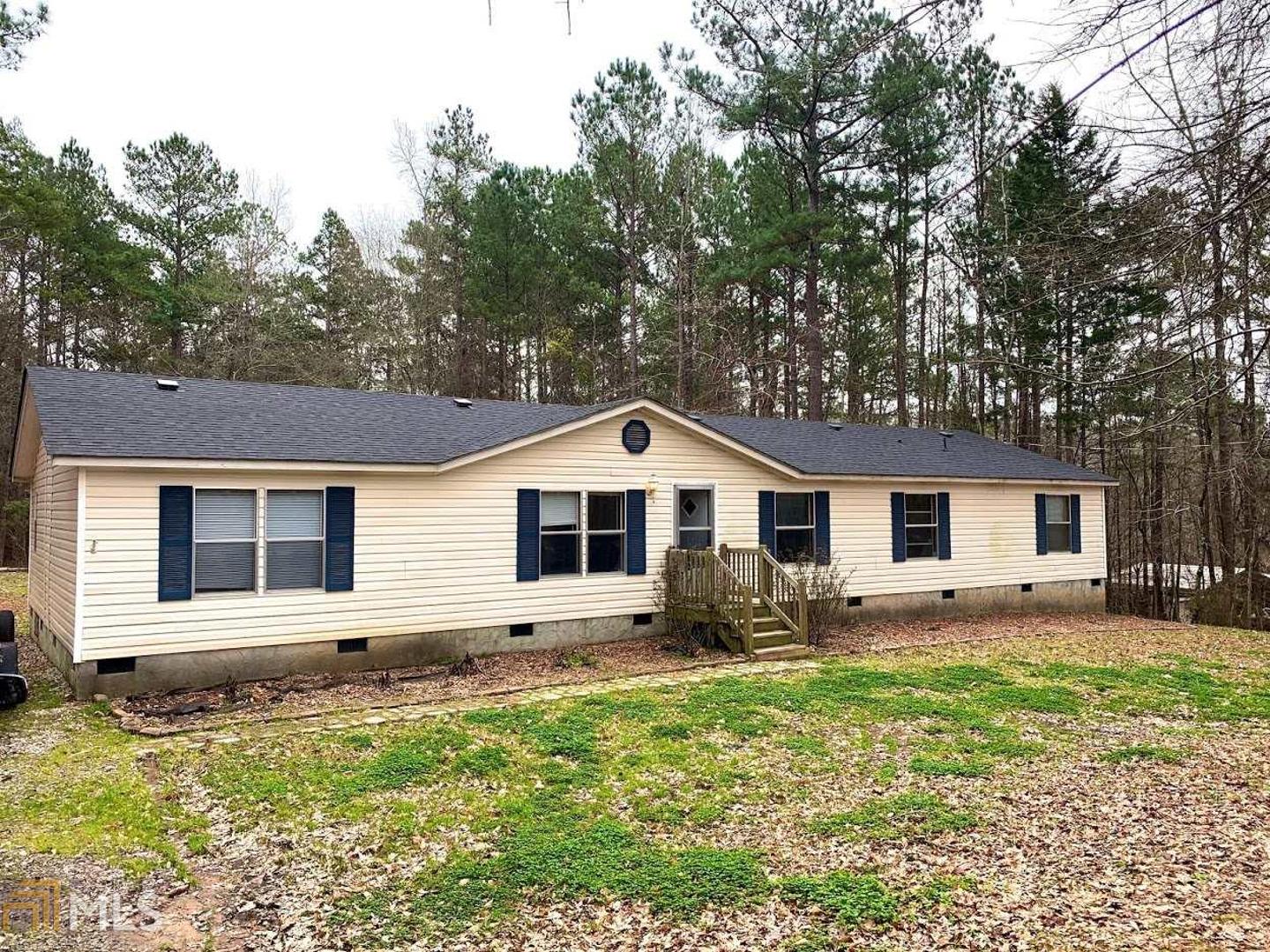 183 Deerfield Road Jackson, GA 30233 - Photo 1 of 1 a front view of house with yard and trees around