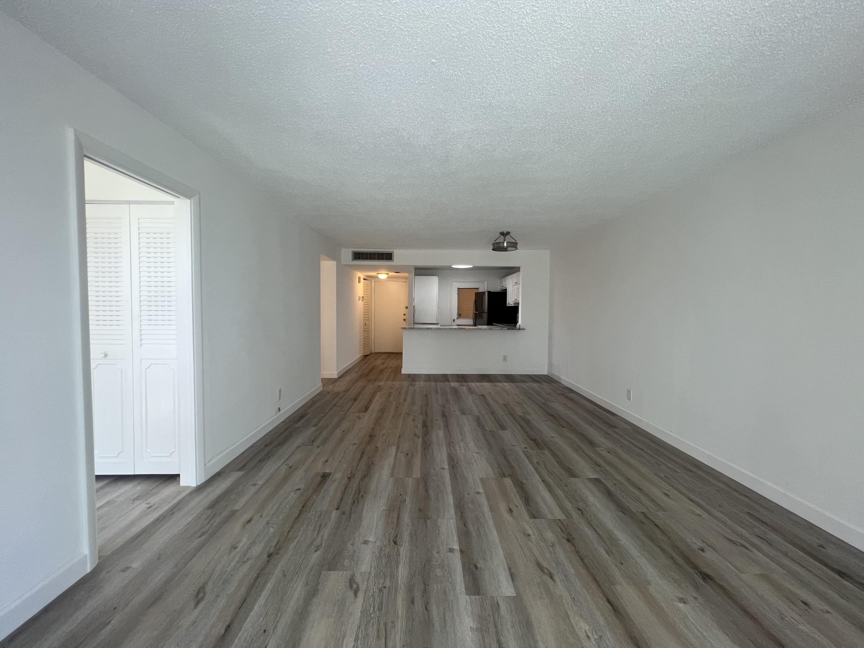 6161 Northwest 2nd Avenue, Unit 114 Boca Raton, FL 33487 - Photo 3 of 15 a view of empty room with wooden floor