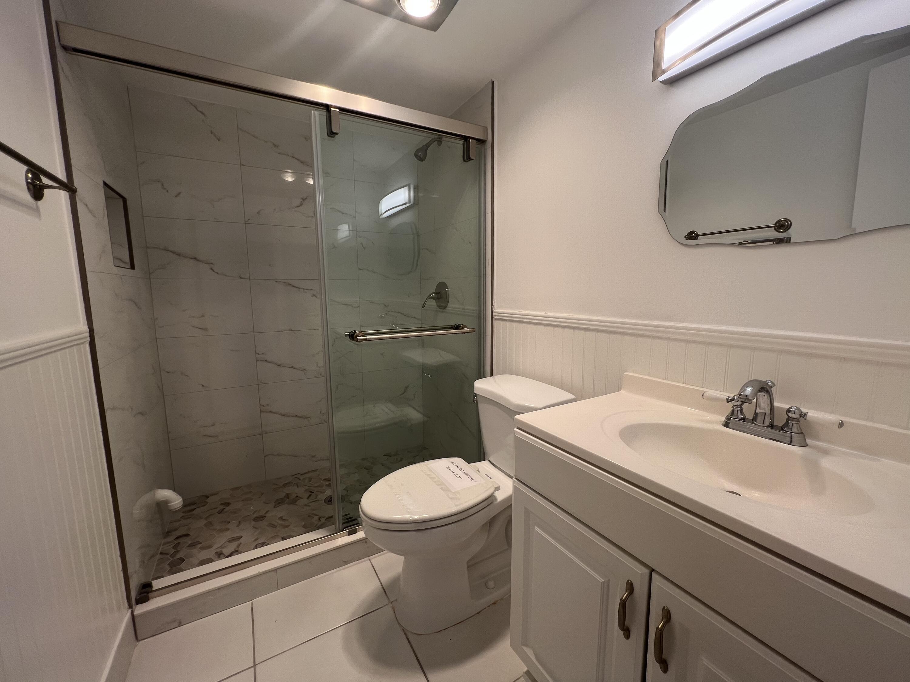 6161 Northwest 2nd Avenue, Unit 114 Boca Raton, FL 33487 - Photo 9 of 15 a bathroom with a sink a toilet and shower