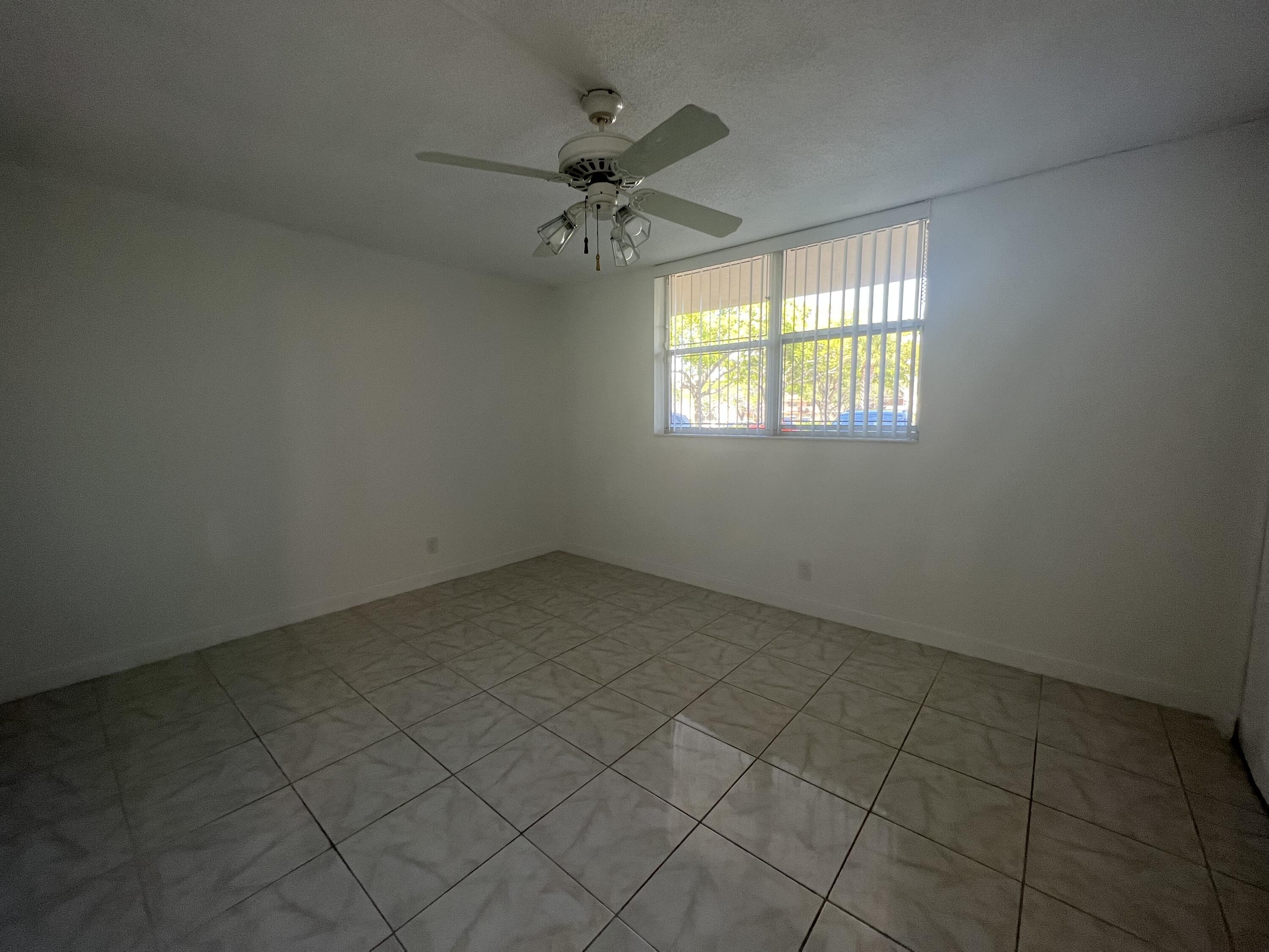 6161 Northwest 2nd Avenue, Unit 114 Boca Raton, FL 33487 - Photo 10 of 15 an empty room with a window