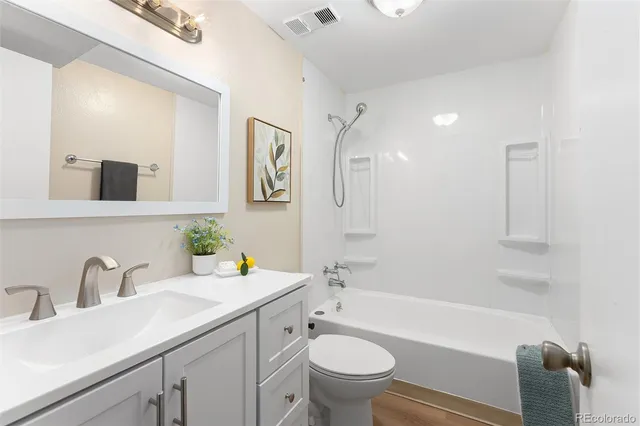 a bathroom with a sink double vanity granite toilet tub and shower