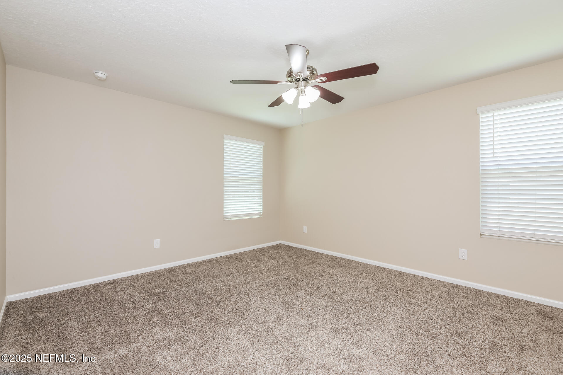 43 Cody Street St. Augustine, FL 32084 - Photo 12 of 15 an empty room with windows and fan