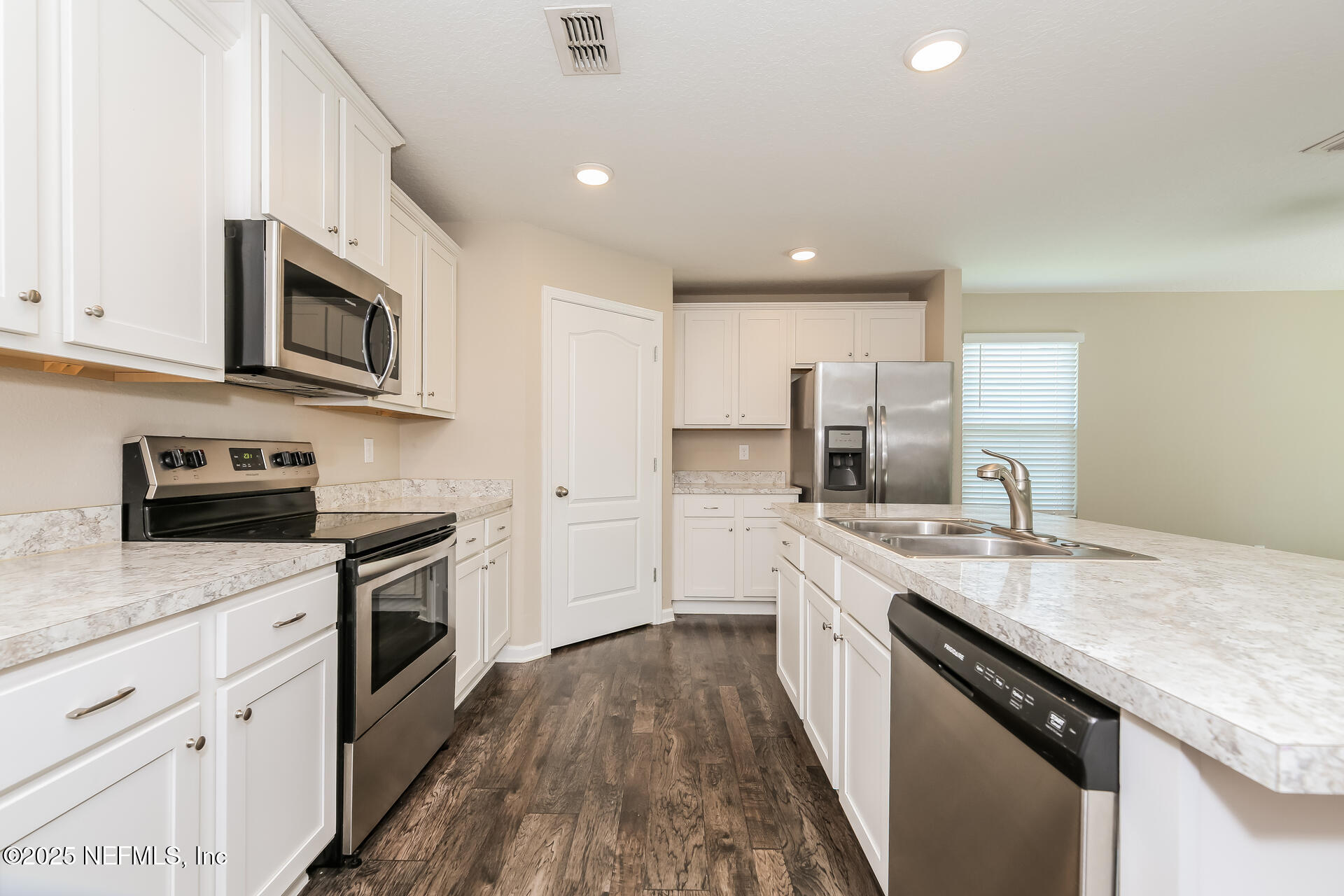 43 Cody Street St. Augustine, FL 32084 - Photo 4 of 15 a kitchen with stainless steel appliances granite countertop a sink stove microwave and cabinets