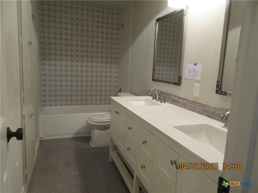 506 East Loop 121 Belton, TX 76513 - Photo 11 of 29 a bathroom with a double vanity sink toilet and shower