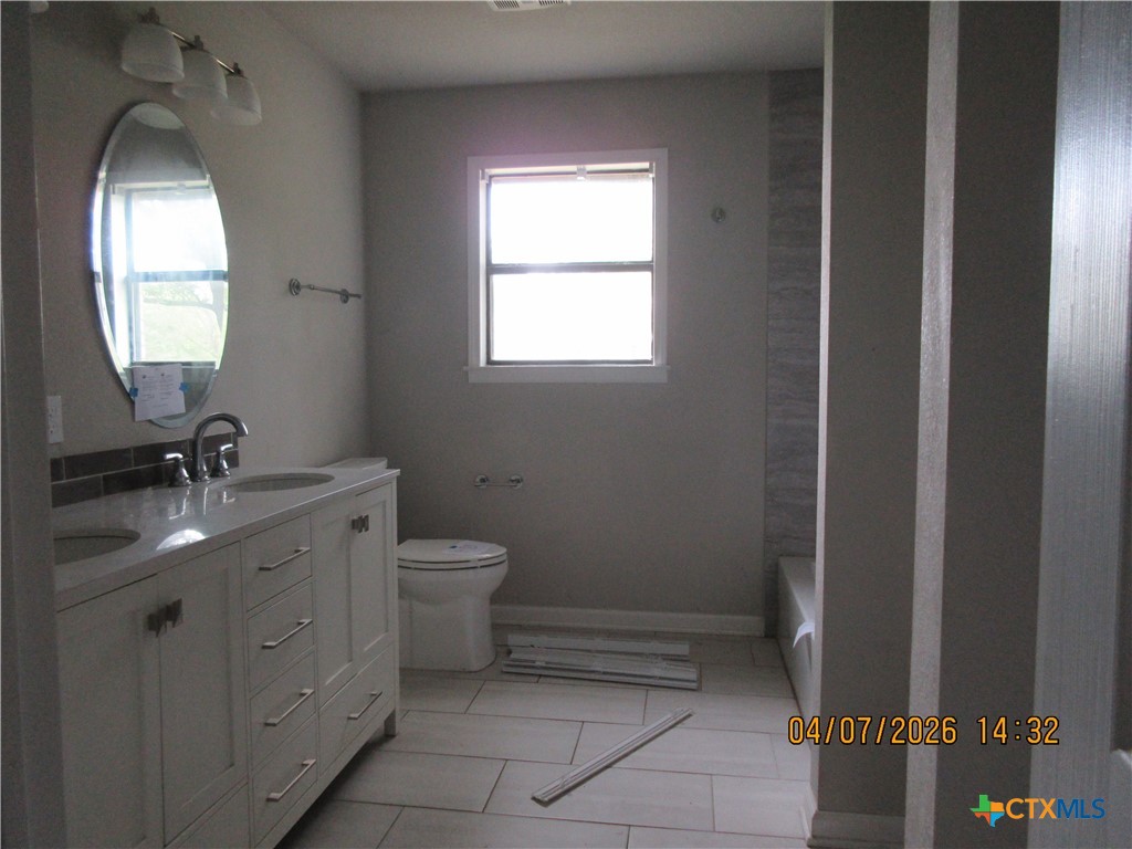 506 East Loop 121 Belton, TX 76513 - Photo 13 of 29 a bathroom with a toilet sink and mirror