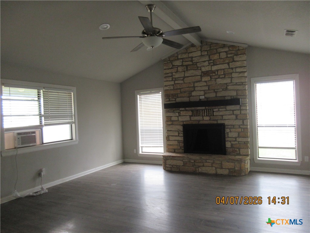 506 East Loop 121 Belton, TX 76513 - Photo 2 of 29 an empty room with wooden floor fireplace and windows