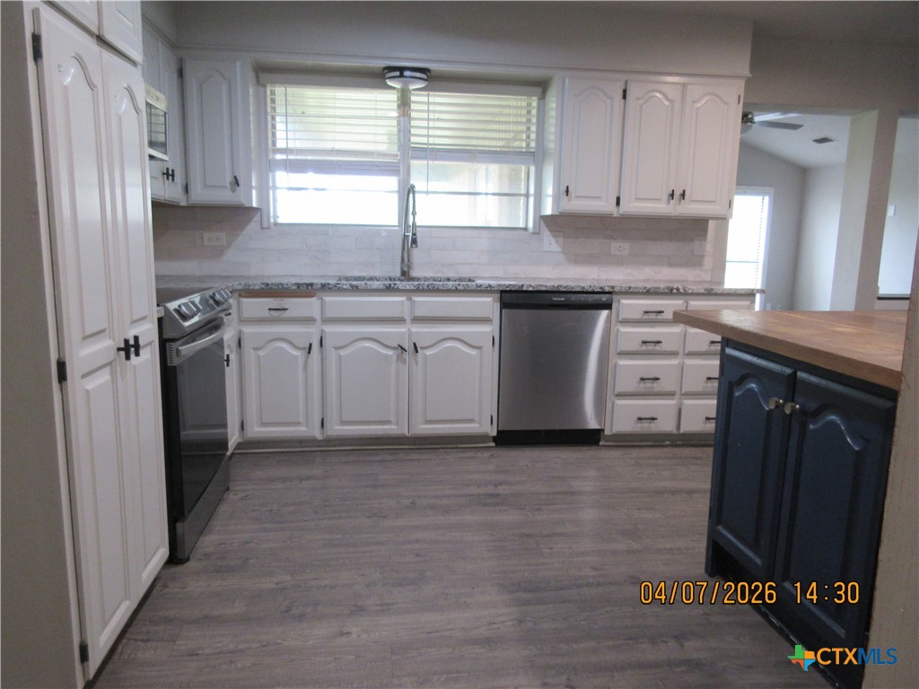 506 East Loop 121 Belton, TX 76513 - Photo 5 of 29 a kitchen with stainless steel appliances granite countertop a stove a sink and a refrigerator