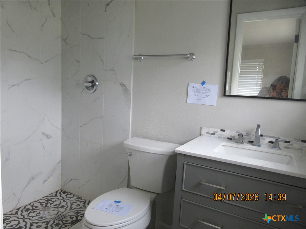 506 East Loop 121 Belton, TX 76513 - Photo 8 of 29 a bathroom with a sink a toilet and a mirror