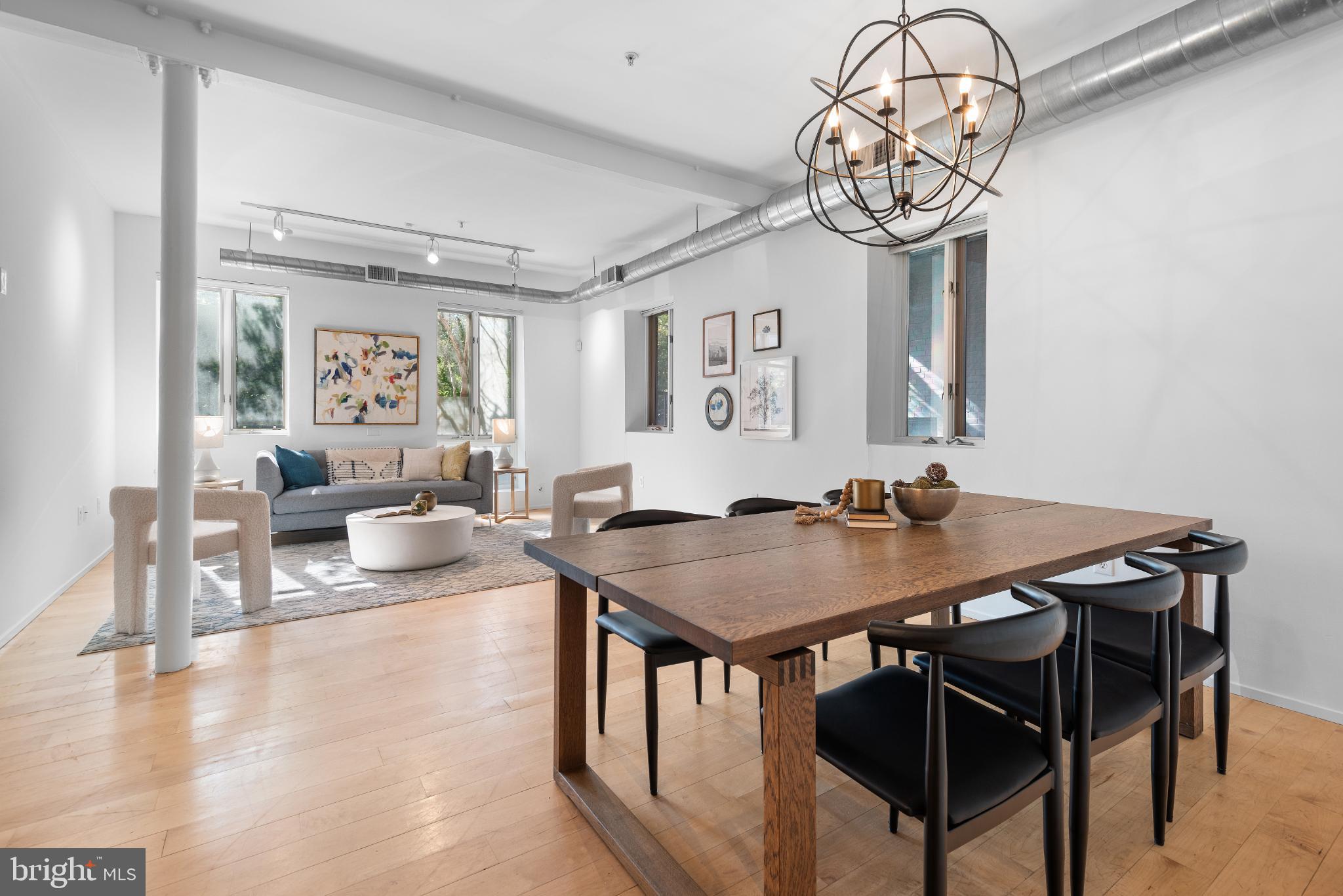 2307 15th Street Northwest, Unit 1 Washington, DC 20009 - Photo 11 of 43 a view of a dining room with furniture a chandelier and wooden floor