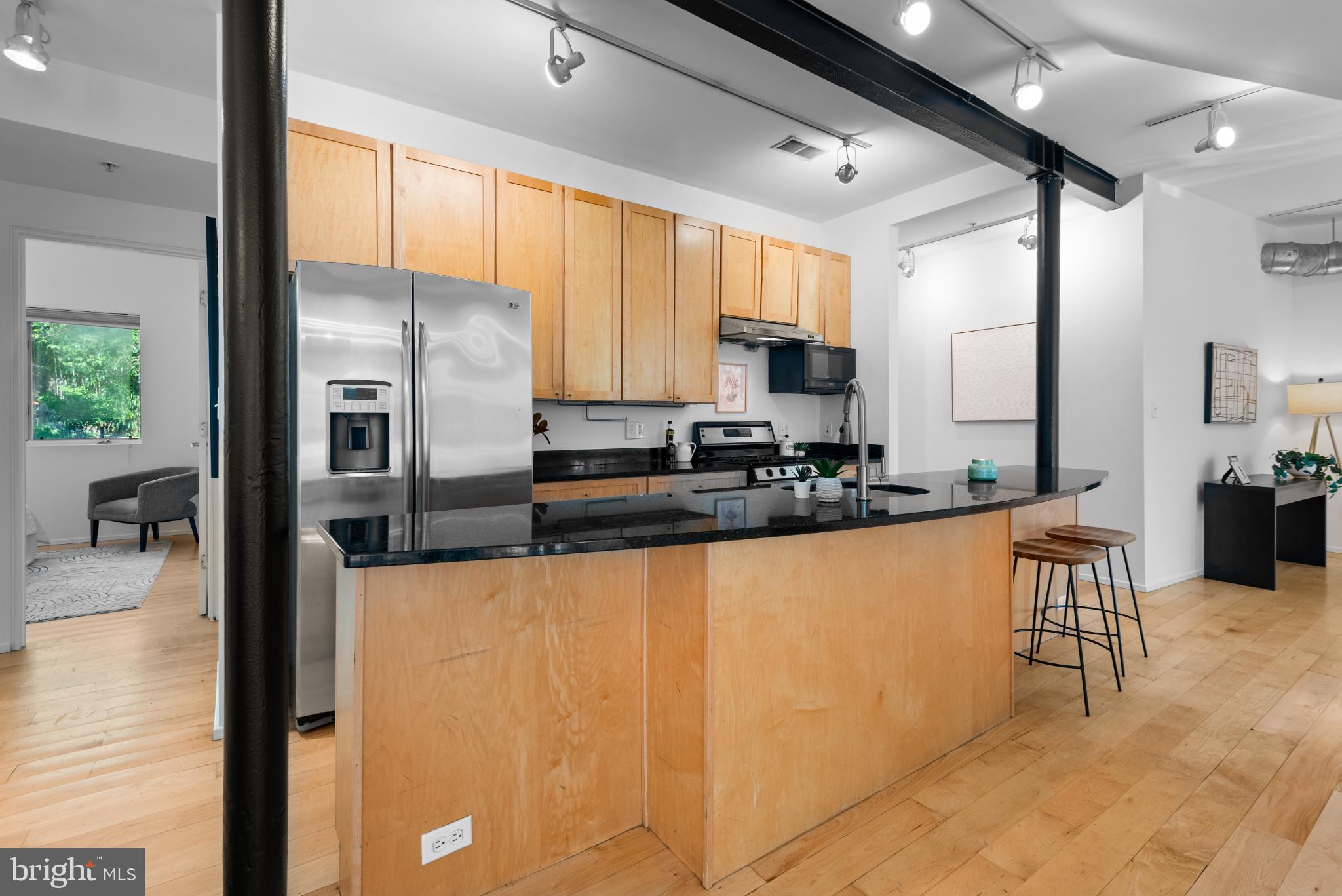 2307 15th Street Northwest, Unit 1 Washington, DC 20009 - Photo 23 of 43 a kitchen with stainless steel appliances a refrigerator a sink a stove and white cabinets next to a window