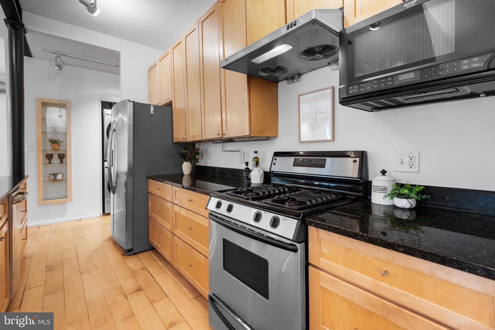 2307 15th Street Northwest, Unit 1 Washington, DC 20009 - Photo 25 of 43 a kitchen with stainless steel appliances granite countertop a stove a refrigerator and a microwave