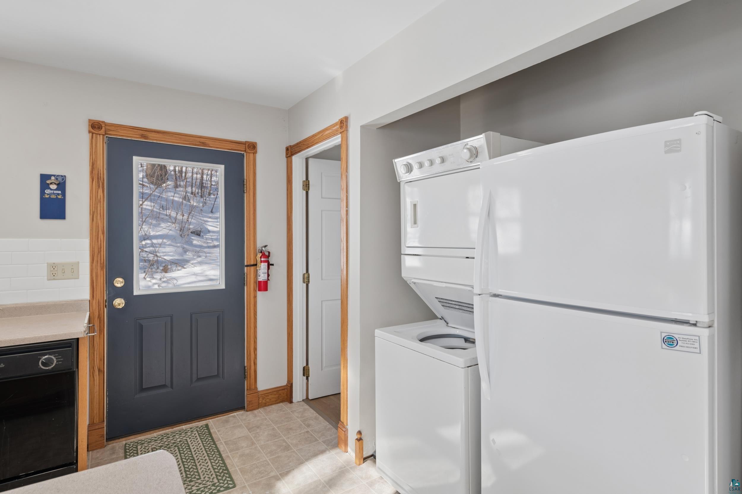 33 South 4th Street Bayfield, WI 54814 - Photo 16 of 29 Laundry area featuring stacked washing machine and dryer and baseboards