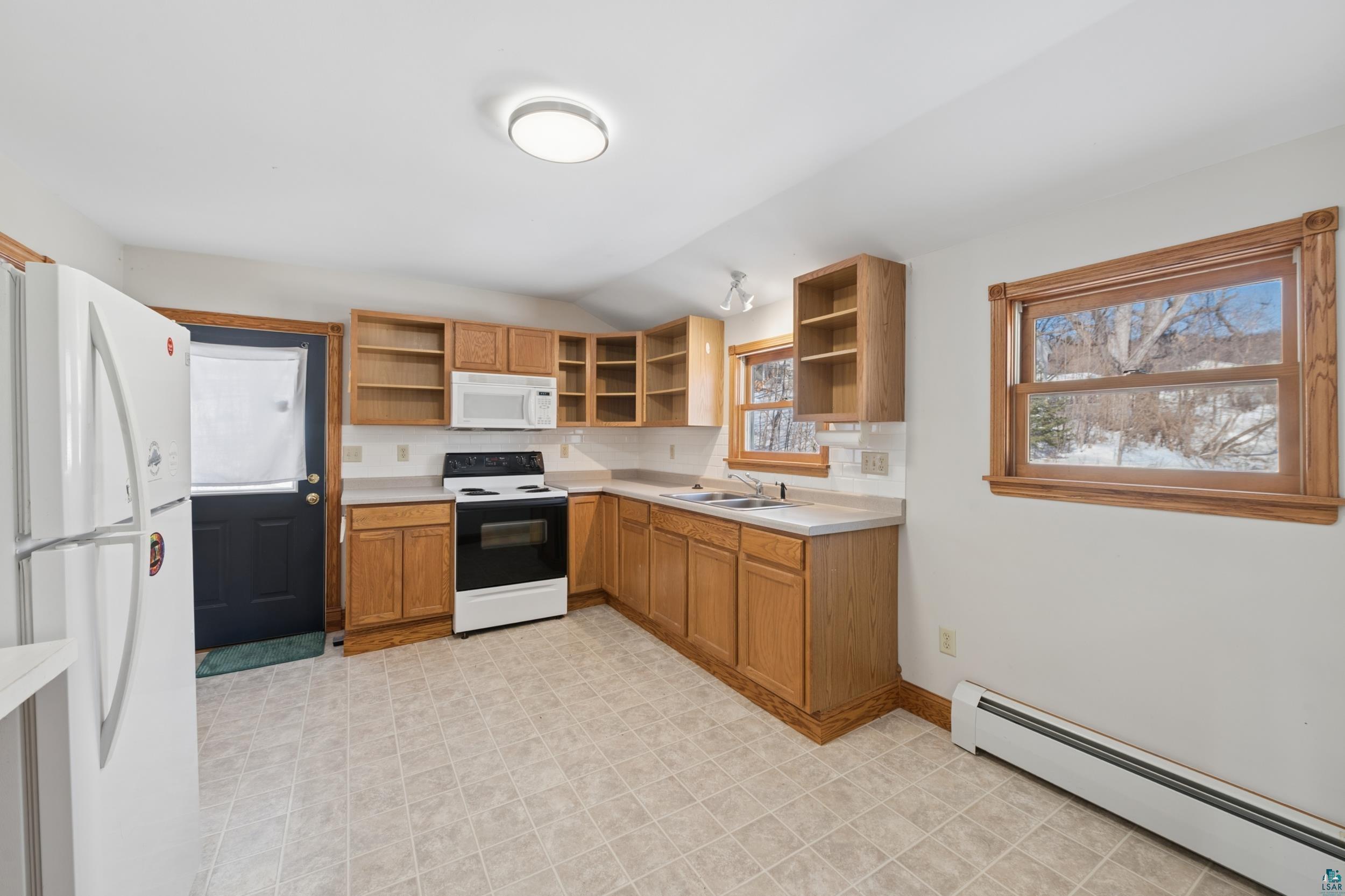 33 South 4th Street Bayfield, WI 54814 - Photo 17 of 29 Kitchen featuring a baseboard heating unit, white appliances, light countertops, wood finish cabinetry, and open shelves