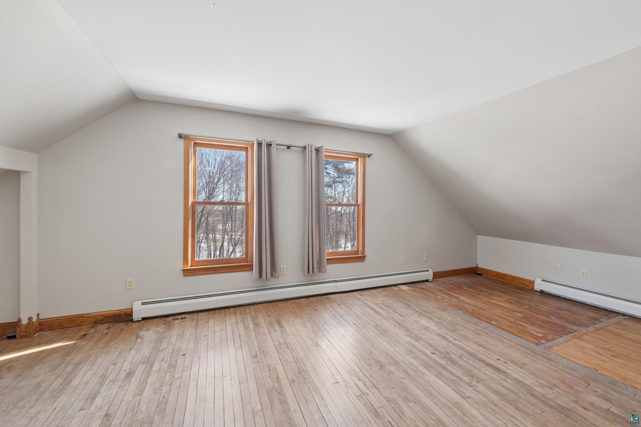 33 South 4th Street Bayfield, WI 54814 - Photo 20 of 29 Bonus room featuring light wood-style floors and a baseboard heating unit