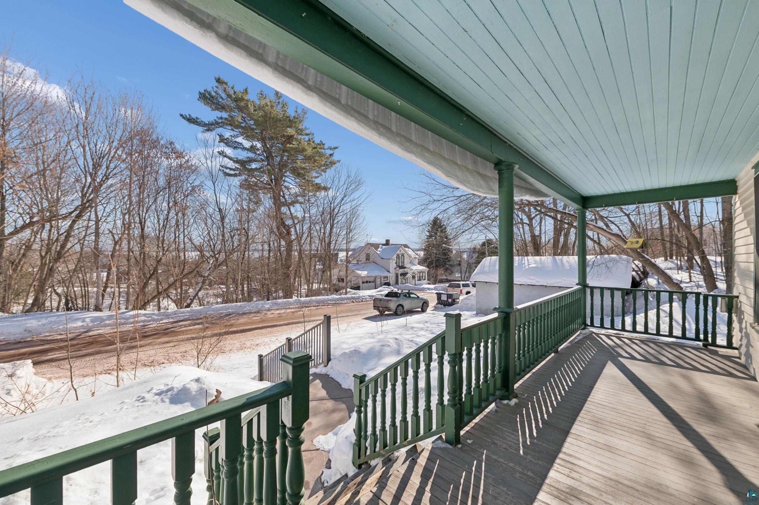 33 South 4th Street Bayfield, WI 54814 - Photo 2 of 29 Snow covered deck featuring a porch and a residential view