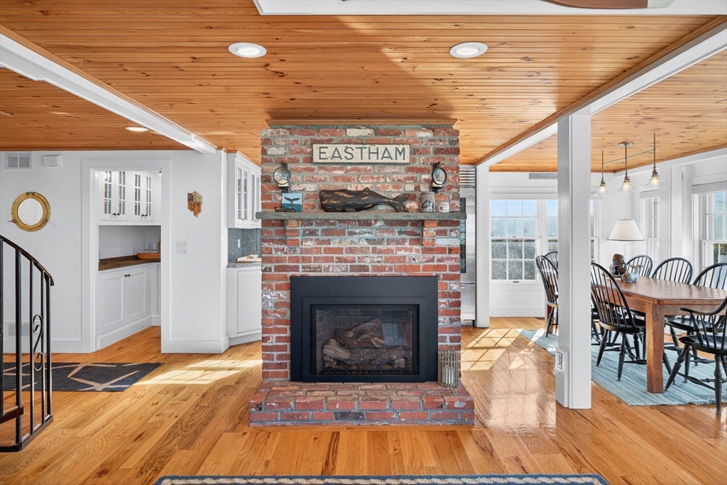 1145 Kingsbury Beach Road Eastham, MA 02642 - Photo 14 of 42 a living room with furniture and a fireplace