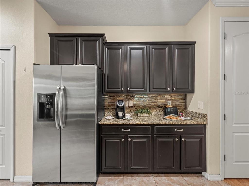 12722 Drakefield Drive Spring Hill, FL 34610 - Photo 12 of 45 a kitchen with stainless steel appliances granite countertop a refrigerator and a sink
