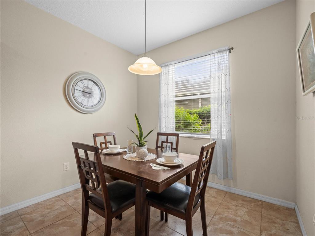 12722 Drakefield Drive Spring Hill, FL 34610 - Photo 16 of 45 a view of a dining room with a table and chairs