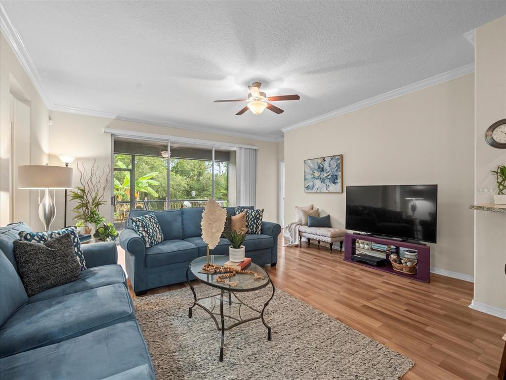 12722 Drakefield Drive Spring Hill, FL 34610 - Photo 20 of 45 a living room with furniture and a flat screen tv