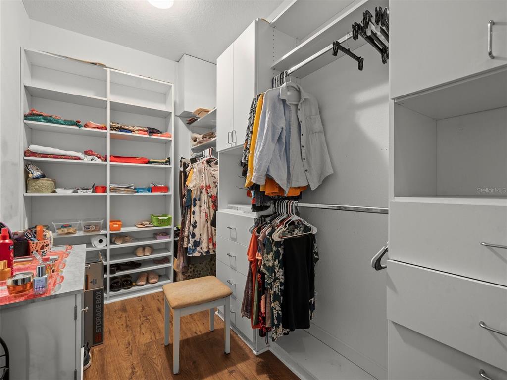 12722 Drakefield Drive Spring Hill, FL 34610 - Photo 29 of 45 a view of walk in closet with clothes and shoes