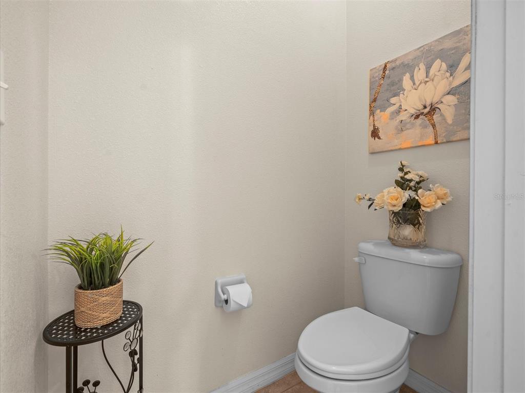 12722 Drakefield Drive Spring Hill, FL 34610 - Photo 32 of 45 a white toilet sitting next to a bathroom sink