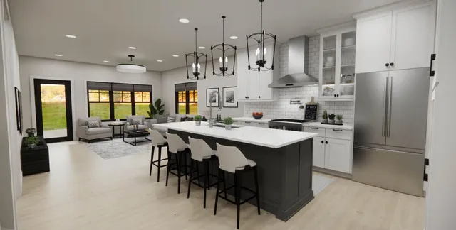 a kitchen with stainless steel appliances kitchen island a table chairs refrigerator and sink
