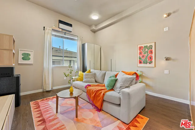 a bedroom with furniture and a wooden floor