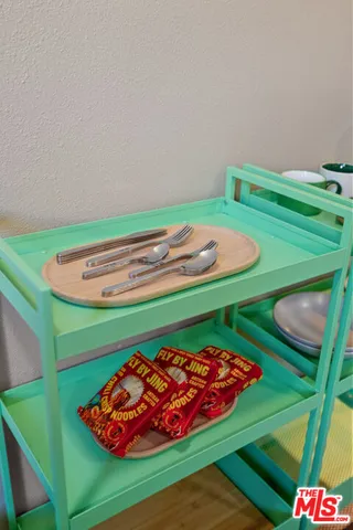 a living room with furniture a large window and wooden floor