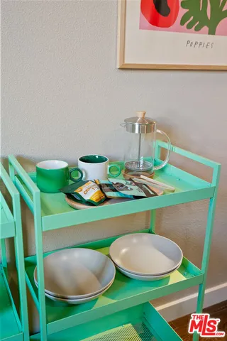 a living room with furniture kitchen view and large windows