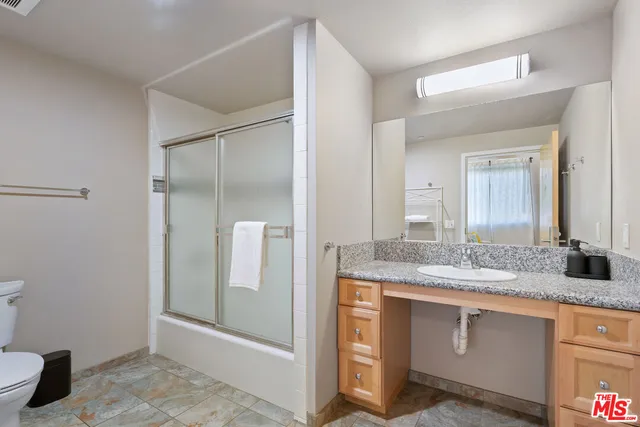 a bathroom with a glass shower door