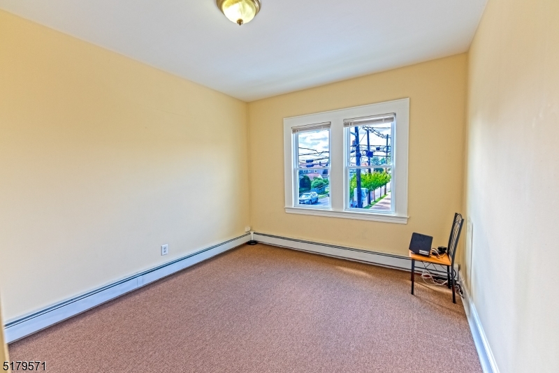 146 Main Street, Unit 2 Garfield, NJ 07026 - Photo 12 of 14 a view of a room with a window and a wooden floor