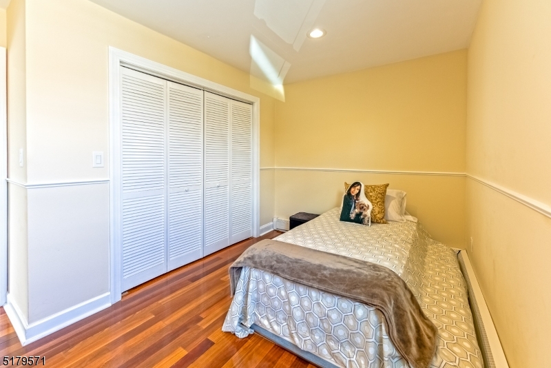 146 Main Street, Unit 2 Garfield, NJ 07026 - Photo 10 of 14 a bedroom with a bed and wooden floor