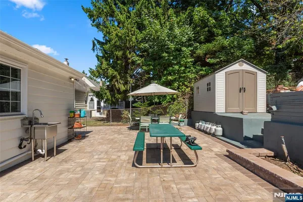 a view of a chairs and table in the back yard of the house