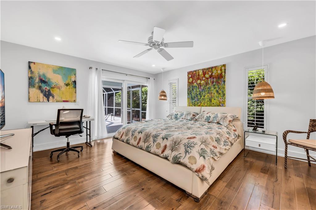 183 Edgemere Way South Naples, FL 34105 - Photo 12 of 42 Bedroom with access to exterior, dark wood-style flooring, a desk, ceiling fan, and recessed lighting