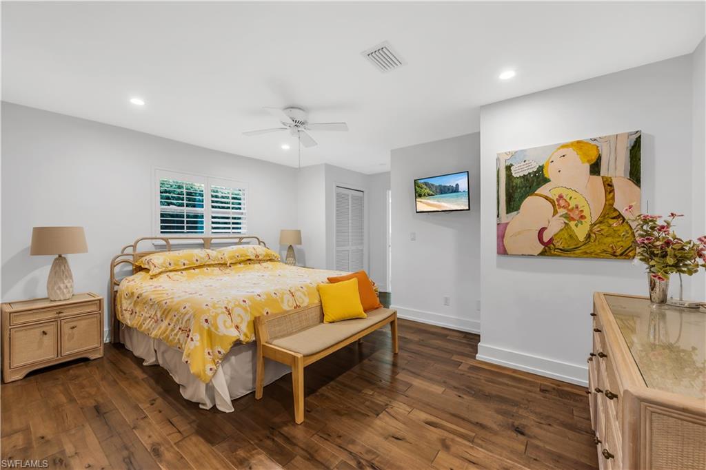 183 Edgemere Way South Naples, FL 34105 - Photo 14 of 42 Bedroom with dark wood-type flooring, a closet, recessed lighting, and a ceiling fan