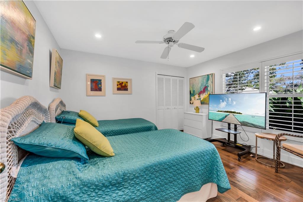 183 Edgemere Way South Naples, FL 34105 - Photo 16 of 42 Bedroom with a closet, hardwood / wood-style flooring, ceiling fan, and recessed lighting