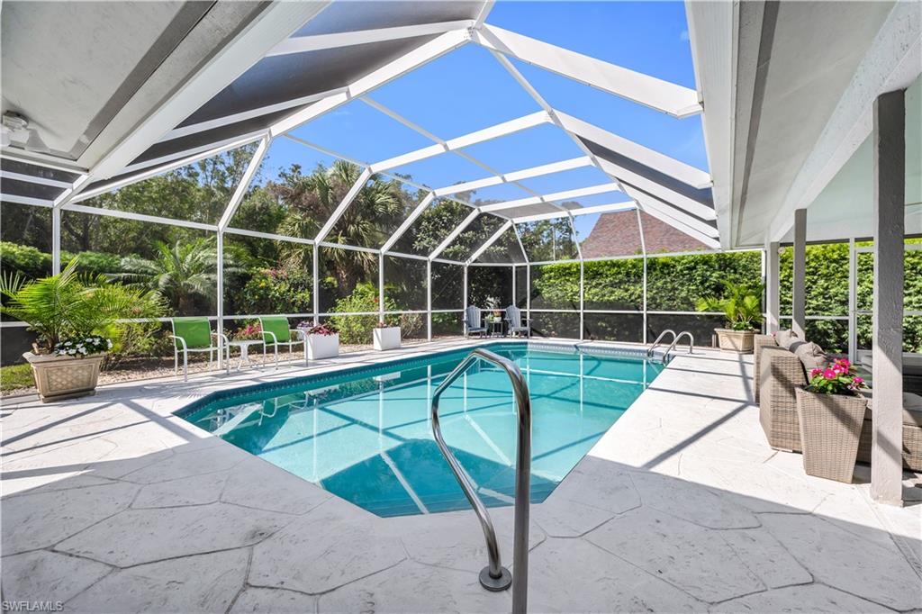 183 Edgemere Way South Naples, FL 34105 - Photo 18 of 42 Swimming pool featuring a patio, glass enclosure, and a sunroom