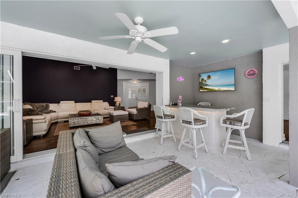 183 Edgemere Way South Naples, FL 34105 - Photo 21 of 42 Living room featuring ceiling fan, bar, and recessed lighting