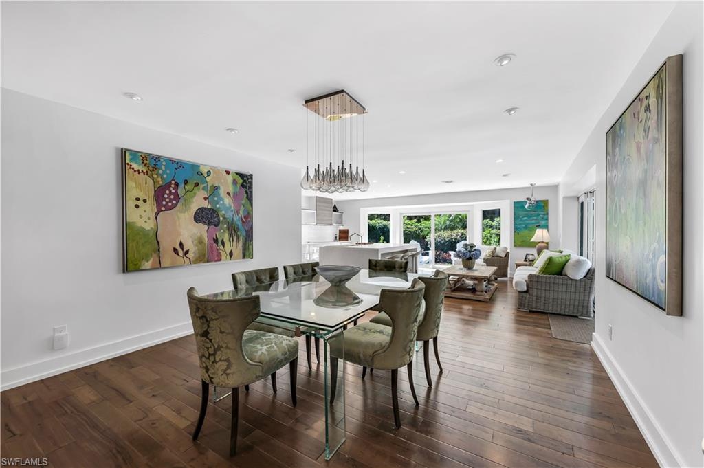 183 Edgemere Way South Naples, FL 34105 - Photo 9 of 42 Dining area featuring baseboards and dark wood-type flooring