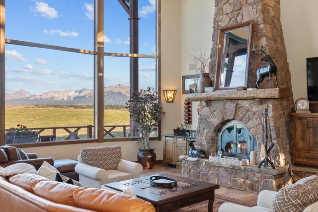 a kitchen with a sink a stove and chairs