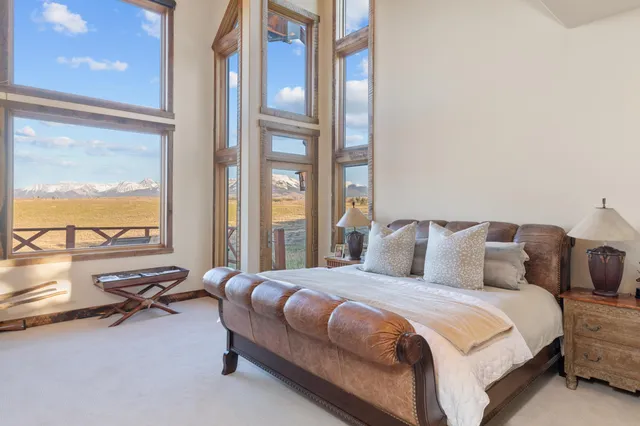 a spacious bathroom with a double vanity sink a mirror a bathtub and next to a window