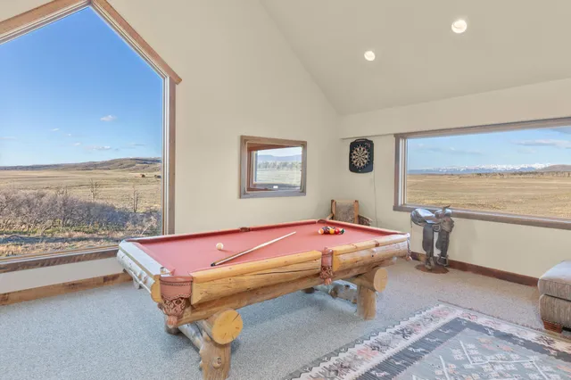 a living room with furniture a rug and a window