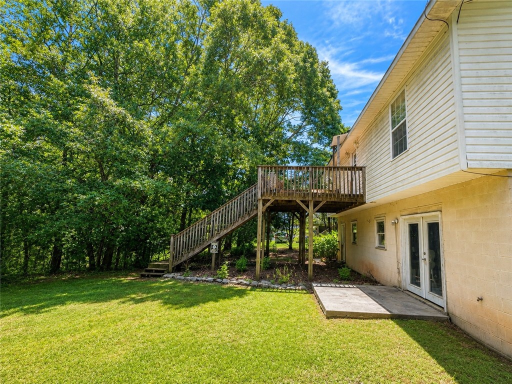 138 Cloverdale Road Seneca, SC 29678 - Photo 4 of 27 A spacious yard leads to a charming elevated deck, perfect for outdoor enjoyment.