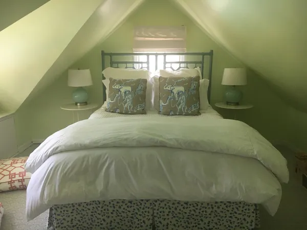 a bed sitting in a room next to a window