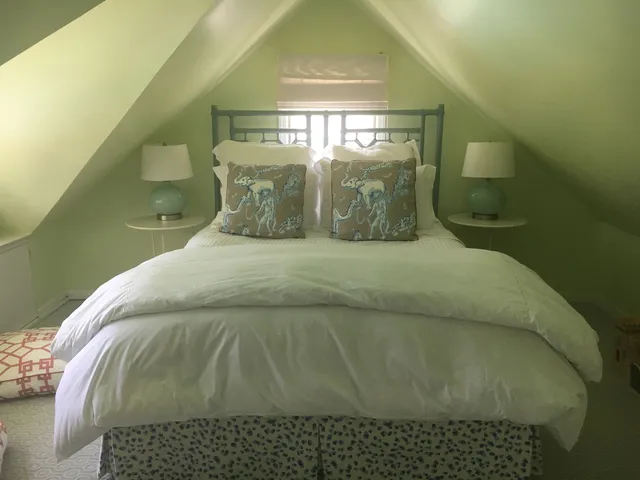 a bed sitting in a room next to a window