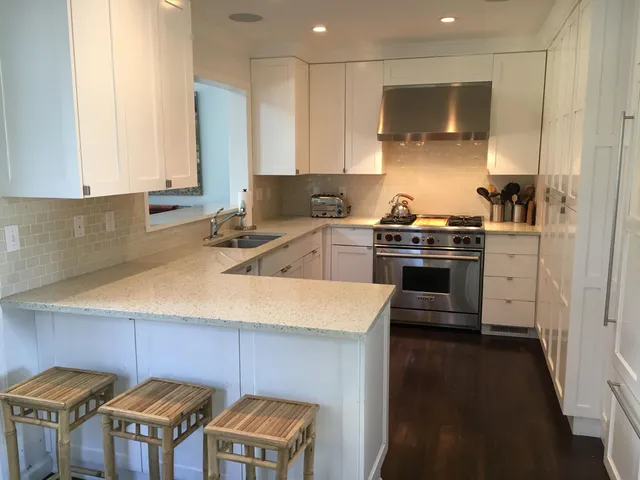 a kitchen with stainless steel appliances a stove a sink a stove and a refrigerator