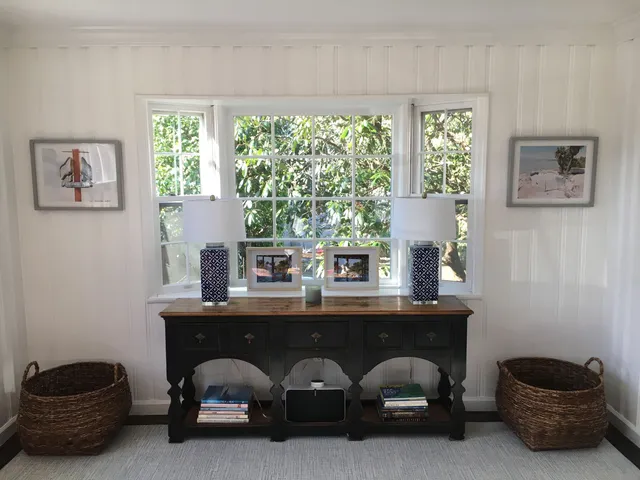 a living room with a table and a potted plant