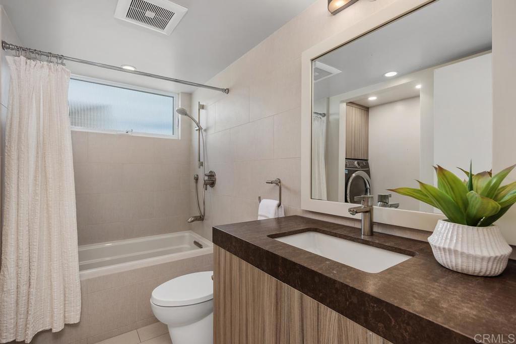 1856 Parliament Road Encinitas, CA 92024 - Photo 32 of 42 a bathroom with a double vanity sink toilet and shower