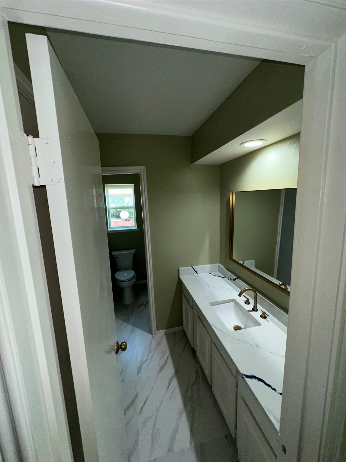 14663 Perthshire Road, Unit 14663 Houston, TX 77079 - Photo 16 of 35 a bathroom with a sink a toilet and mirror